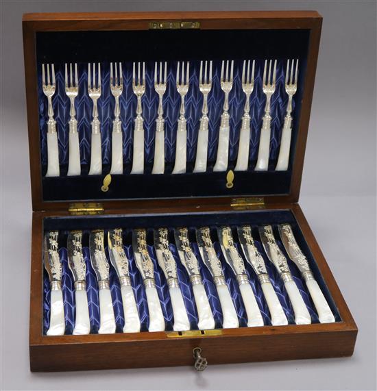 A set of twelve late Victorian plated engraved dessert knives and forks, with mother of pearl pistol handles, cased